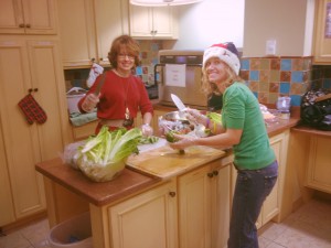 Esther Scott and Michell Musial prepare Ronald McDonald House holiday meals for families of critically ill children.